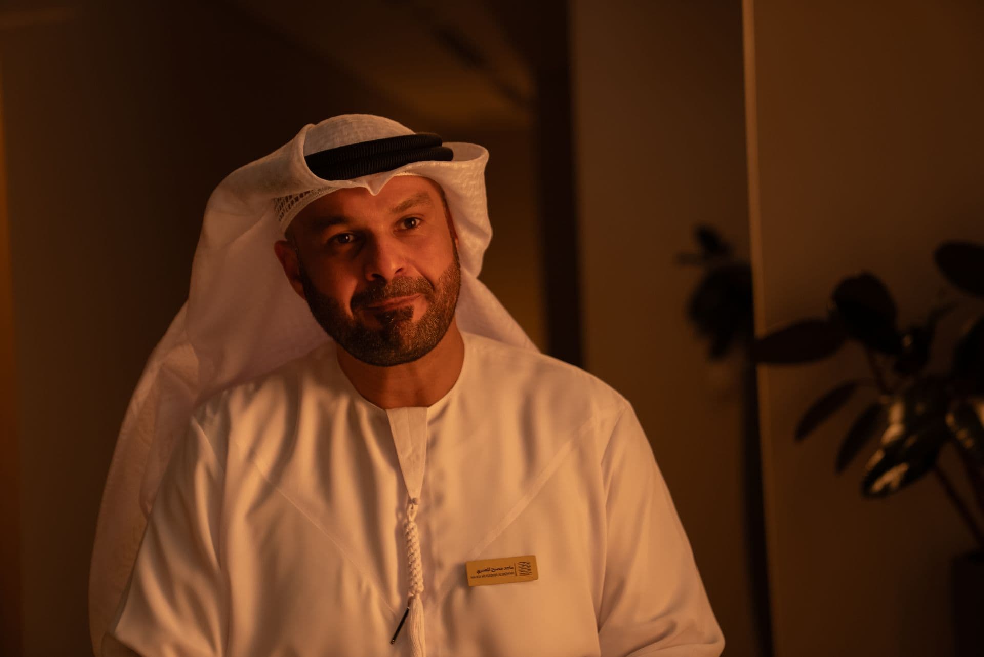 A man in a kandura, warm light