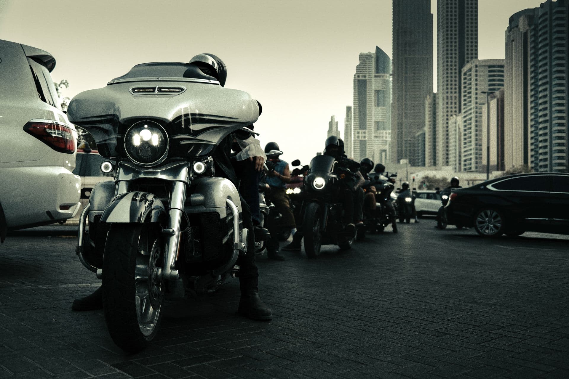 Motorcycles lined up against a city skyline