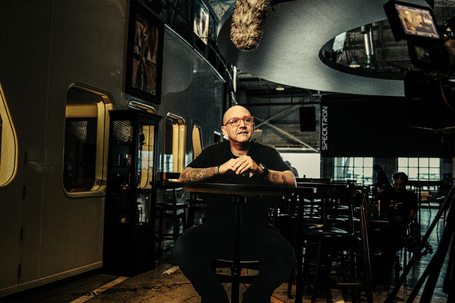 A man being interviewed at a bar