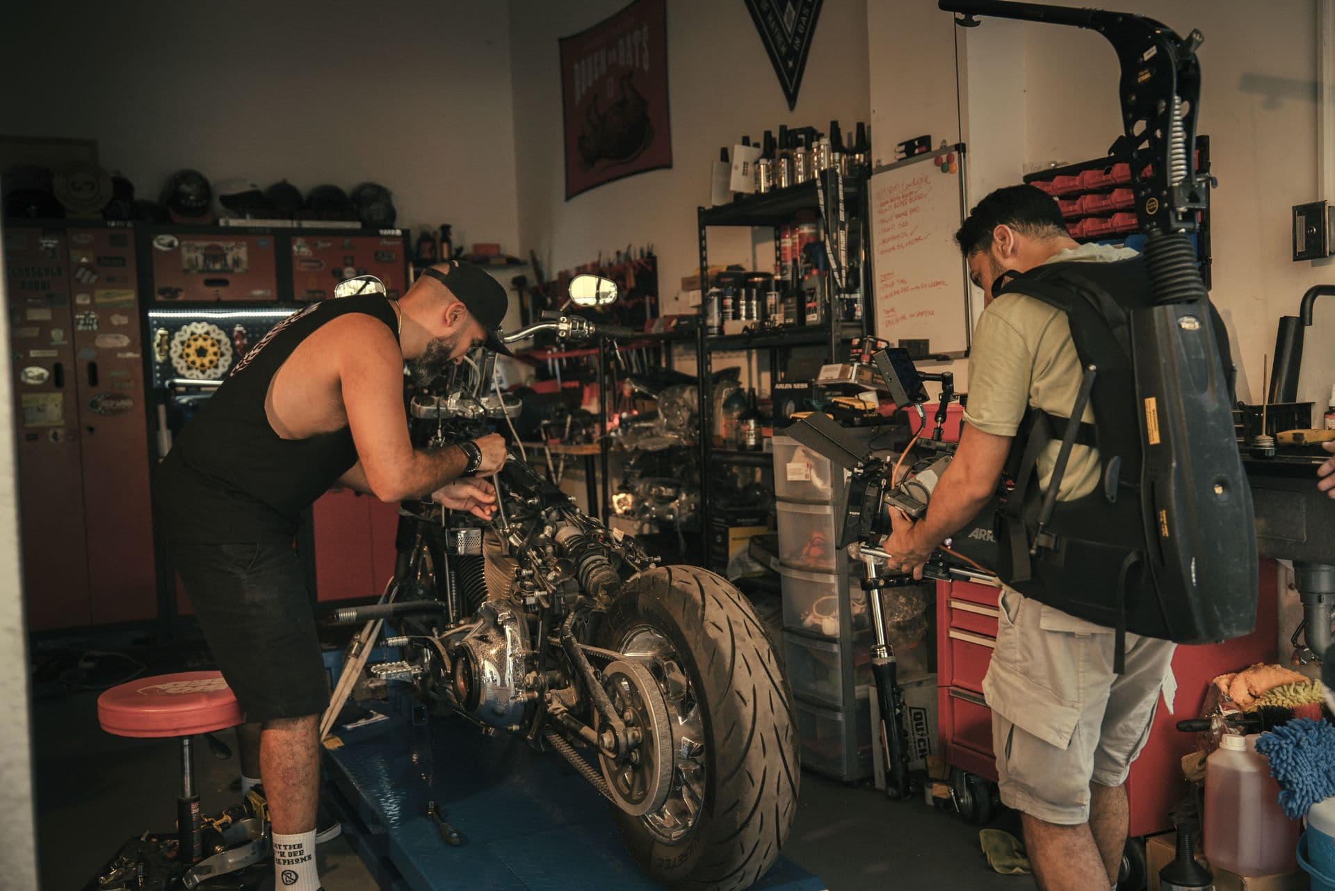 Mechanics working on a motorcycle in a workshop