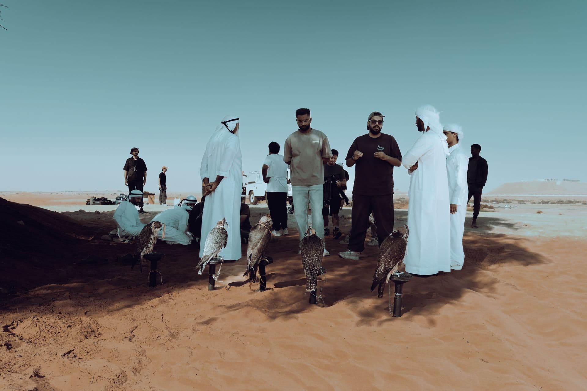 Crew and cast in kanduras in the desert