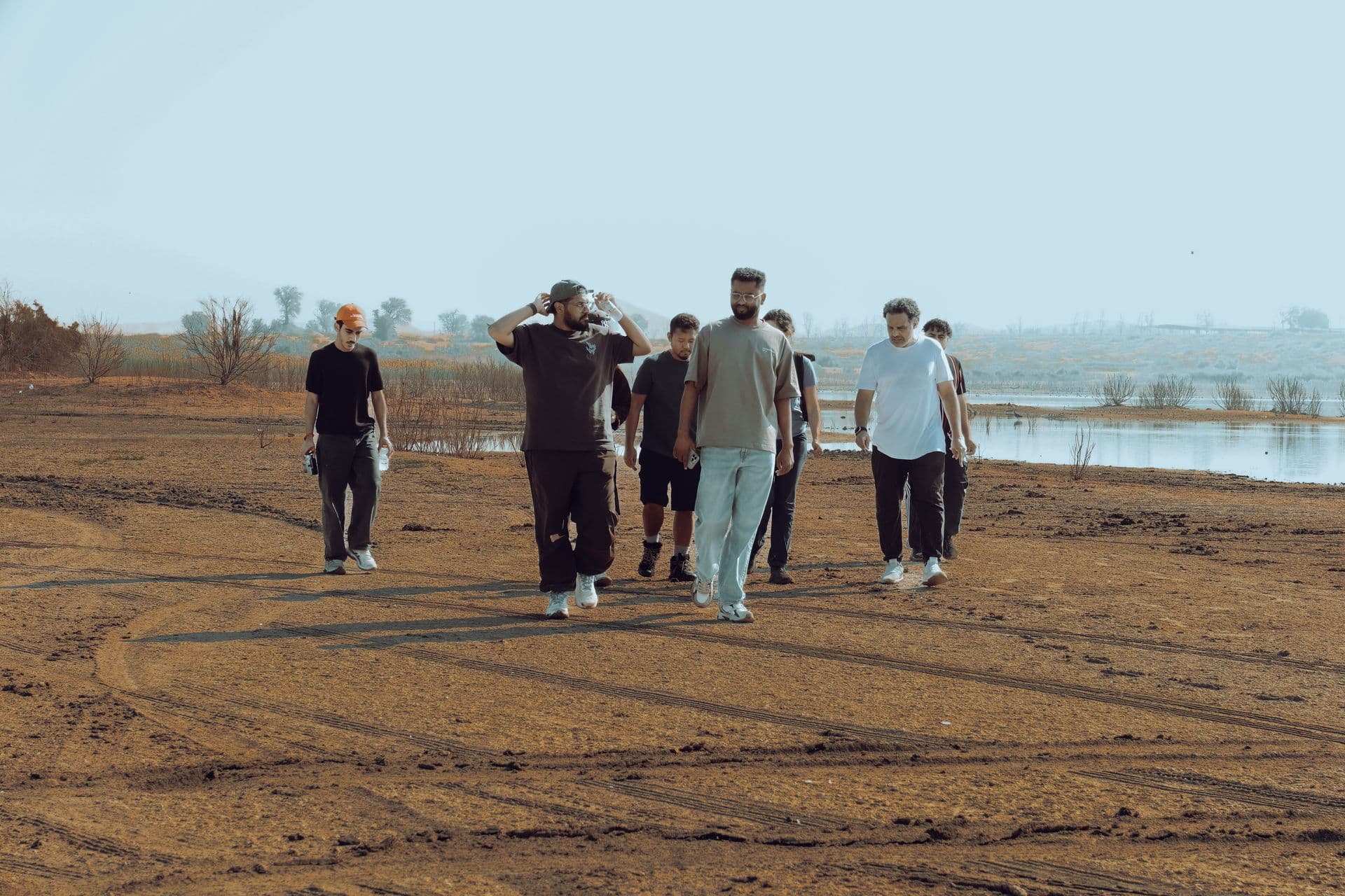 Crew walking by the water in fog