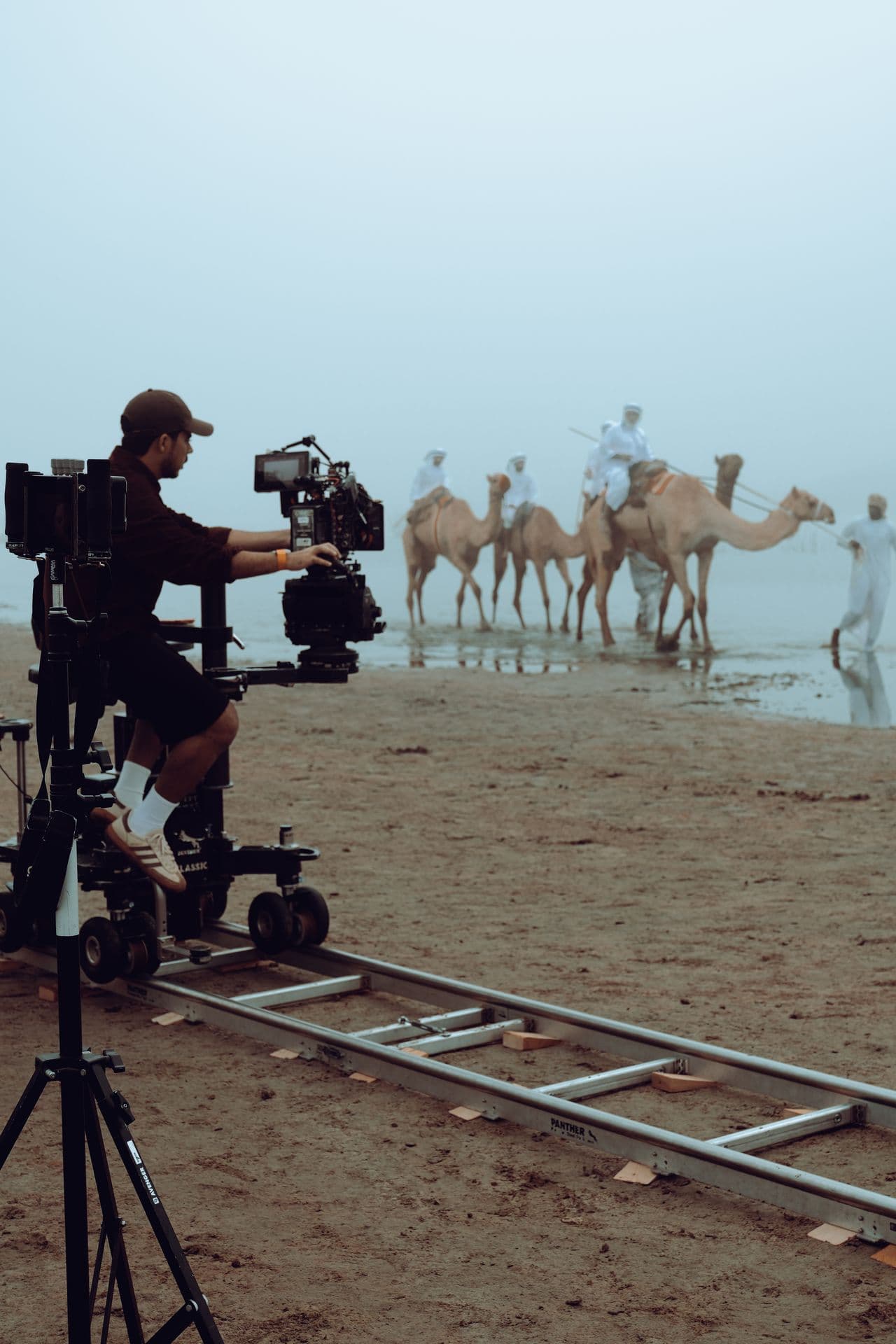 A camera dolly with camels behind