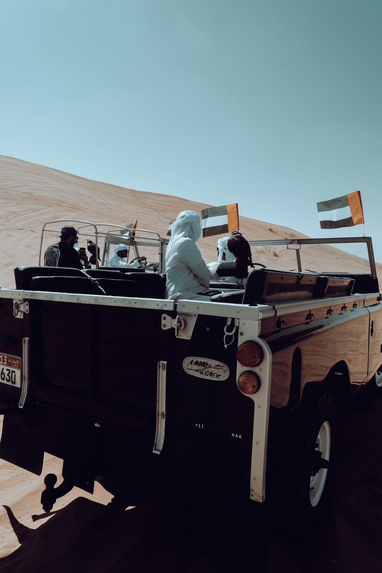 Men with a flag in an open jeep