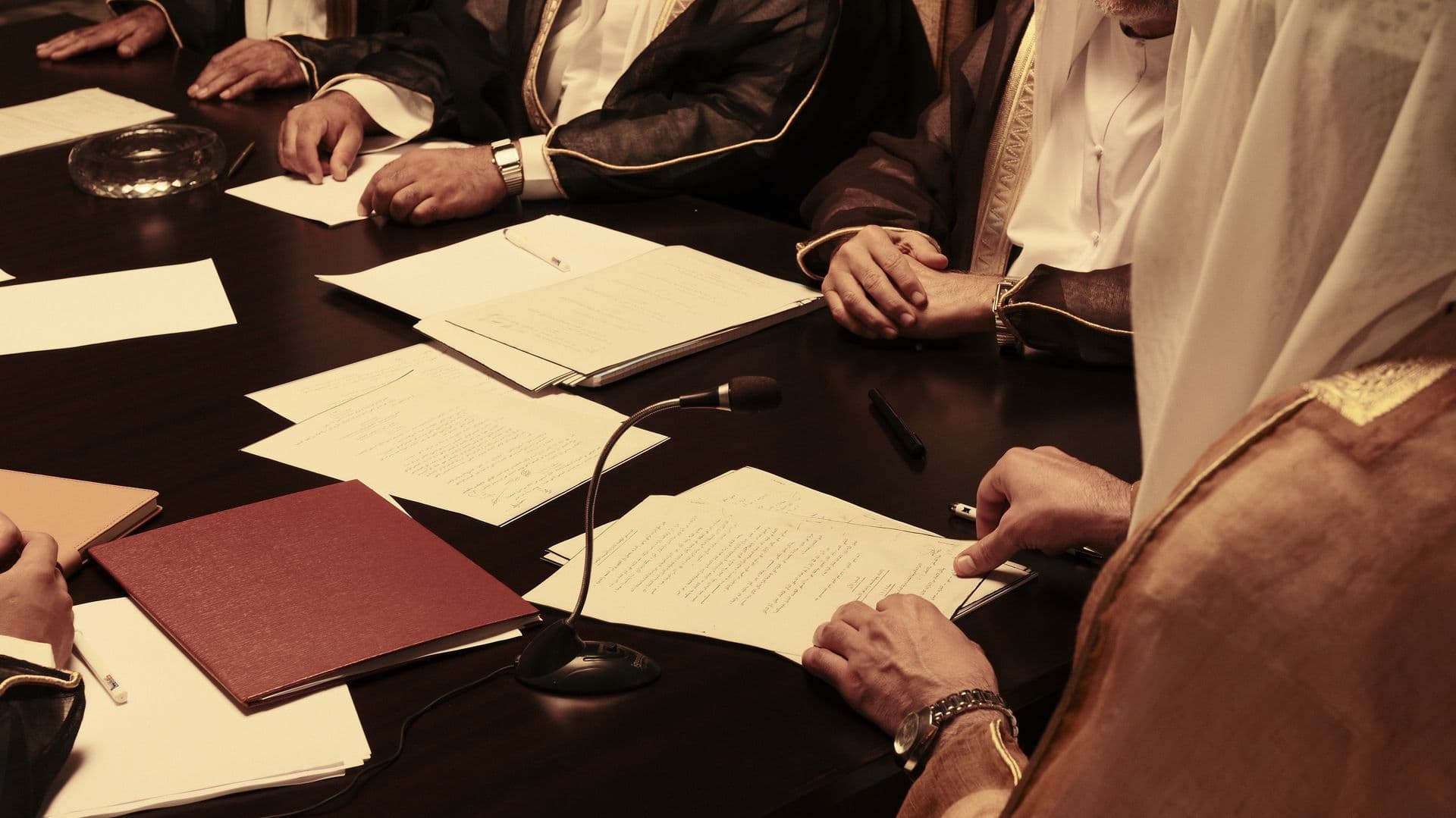 Hands and papers on the negotiation table