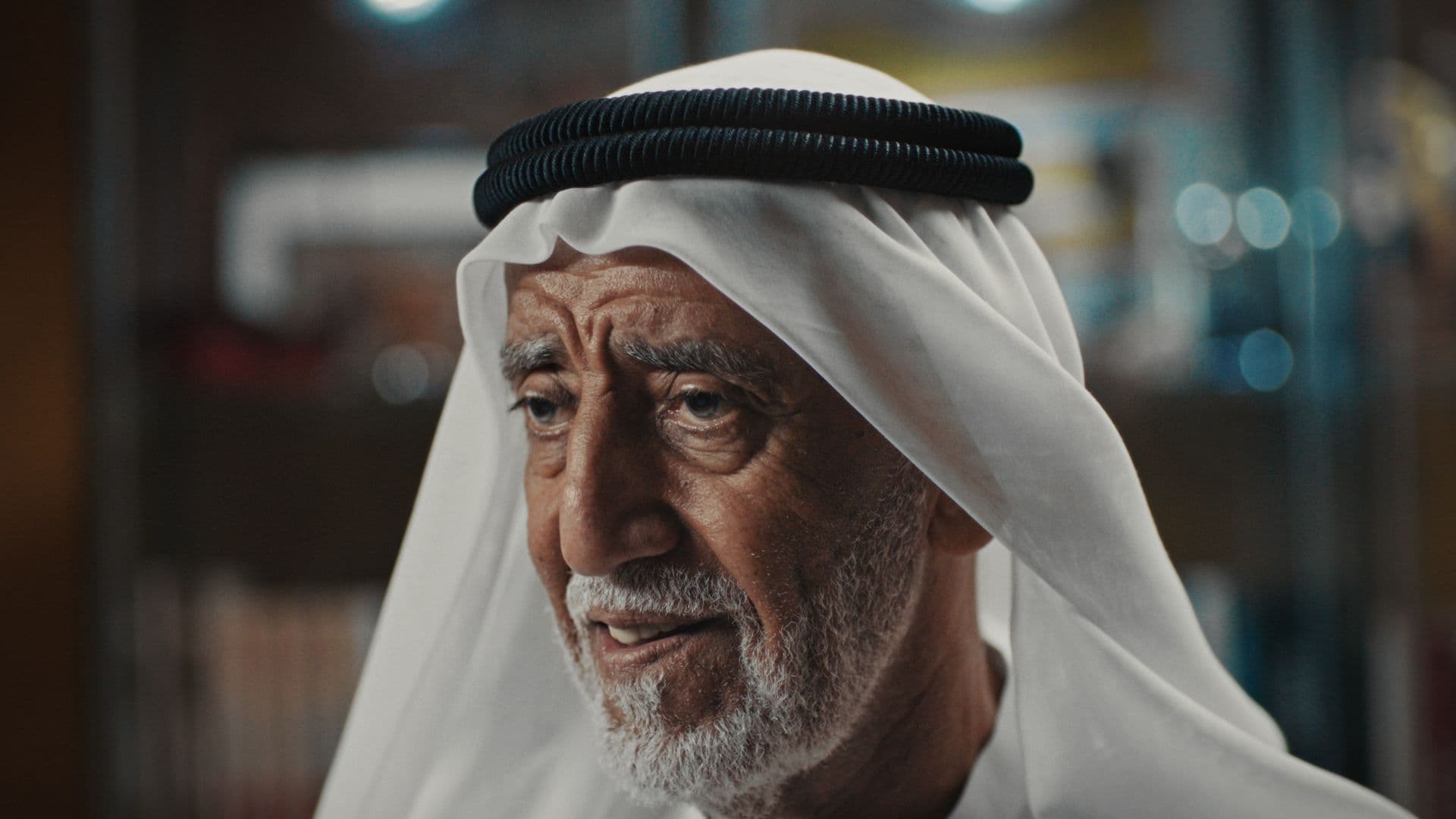 An elder in a white ghutra, close