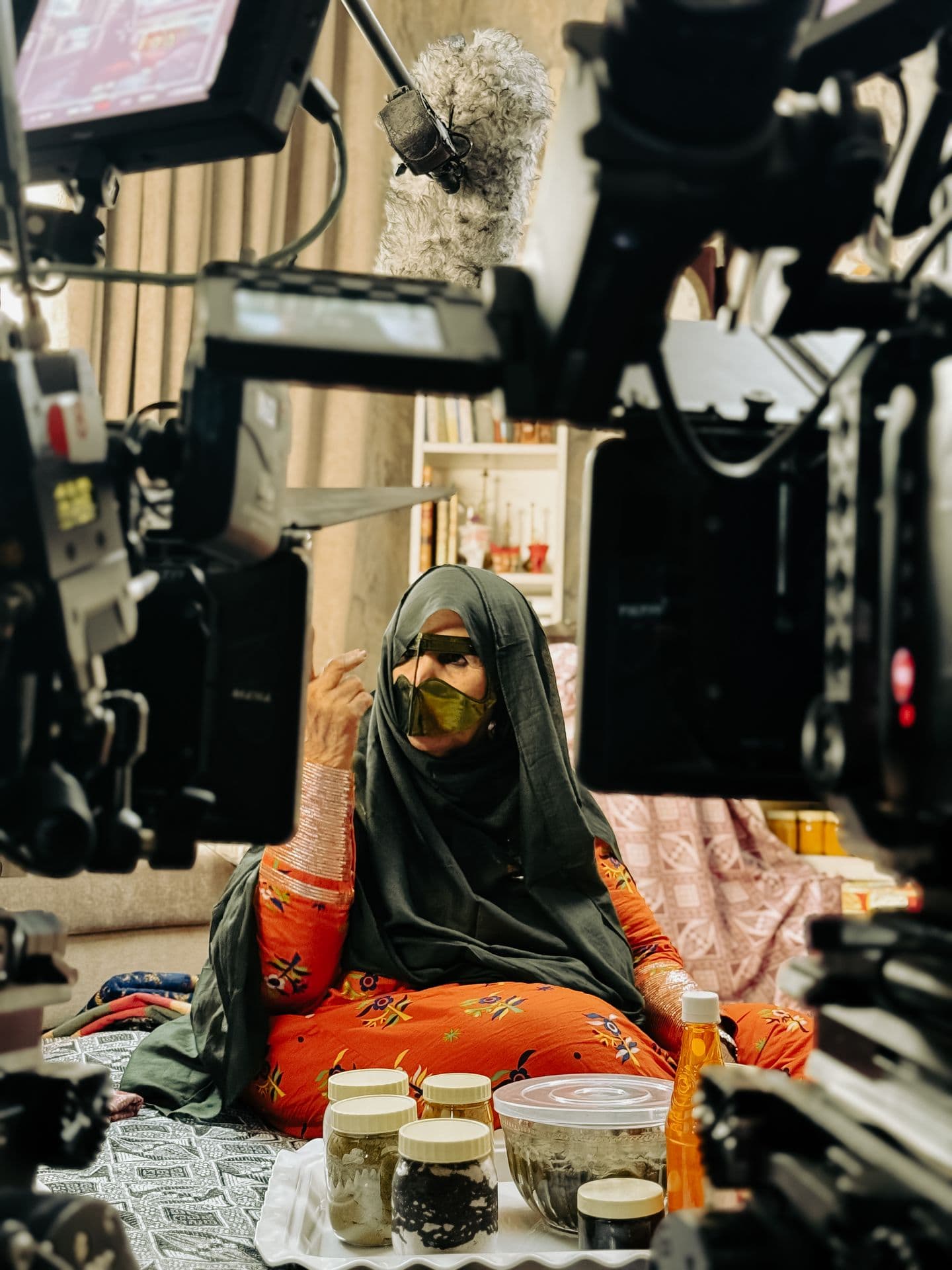 A woman in a gold burqa between takes
